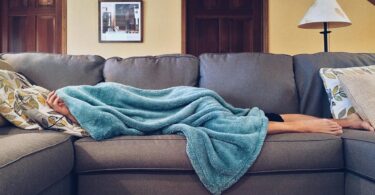 person lying on sofa