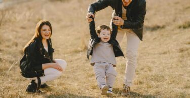 photo of family having fun with soccer ball