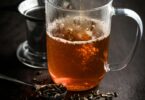 hot tea pouring into glass cup