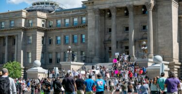 anonymous people protesting against old building in city