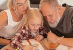 grandparents sitting by the table with the little girl